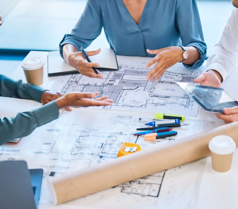 blueprints-architects-building-engineers-talking-meeting-planning-renovation-remodeling-floor-plan-with-tablet-diverse-group-designers-arguing-structure-design-vision-ideas-scaled